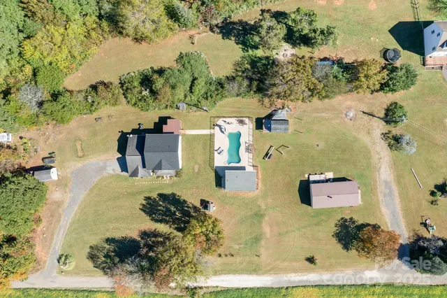 an aerial view of a house with a yard basket ball court