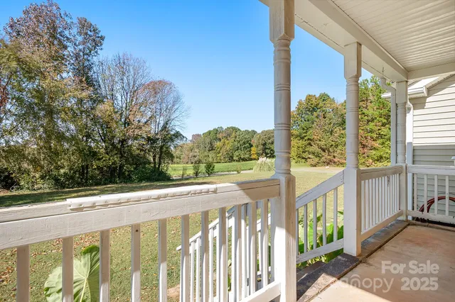 a view of a balcony with trees