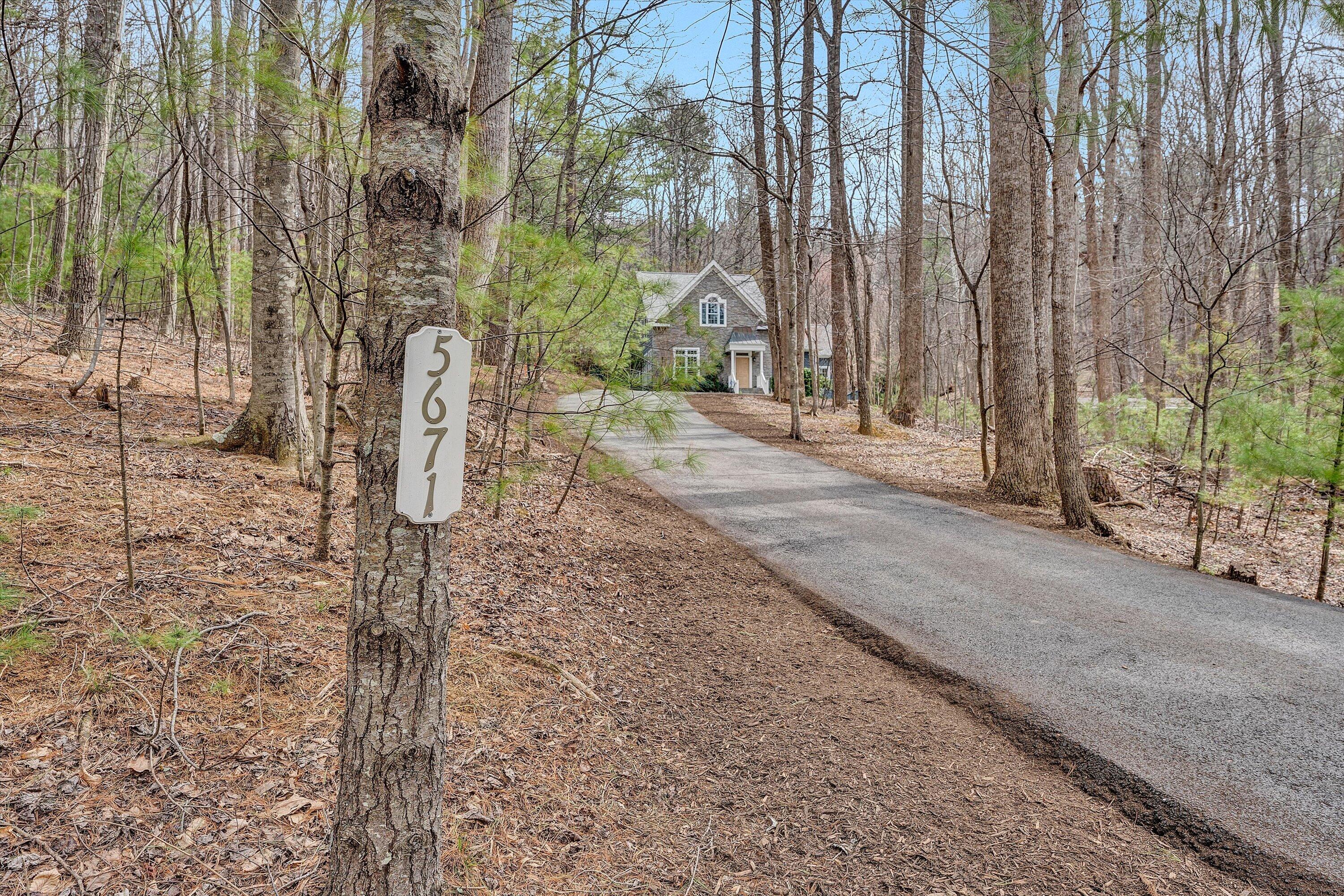5671 Split Rail Lane Roanoke, VA 24018 - Photo 70 of 71 a backyard of a house with lawn chairs and large trees