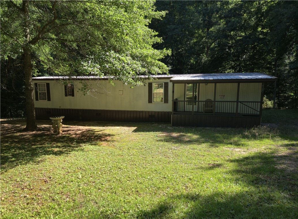 238 Forest Lane Starr, SC 29684 - Photo 1 of 11 A quaint residence nestled amongst a lush, verdant backdrop offers a serene retreat.