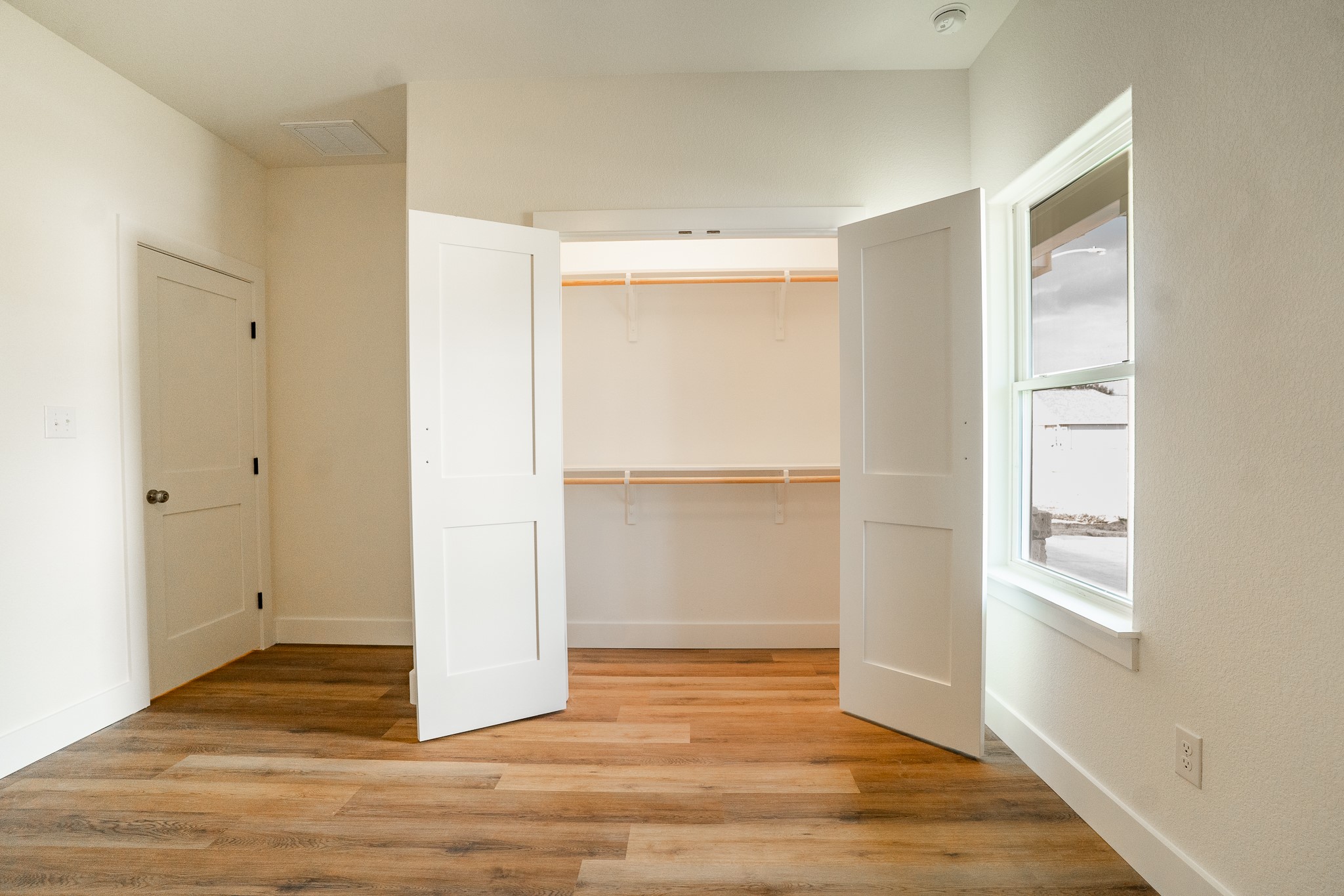 309 String Prairie Way Smithville, TX 78957 - Photo 23 of 30 a view of an empty room with wooden floor and a window