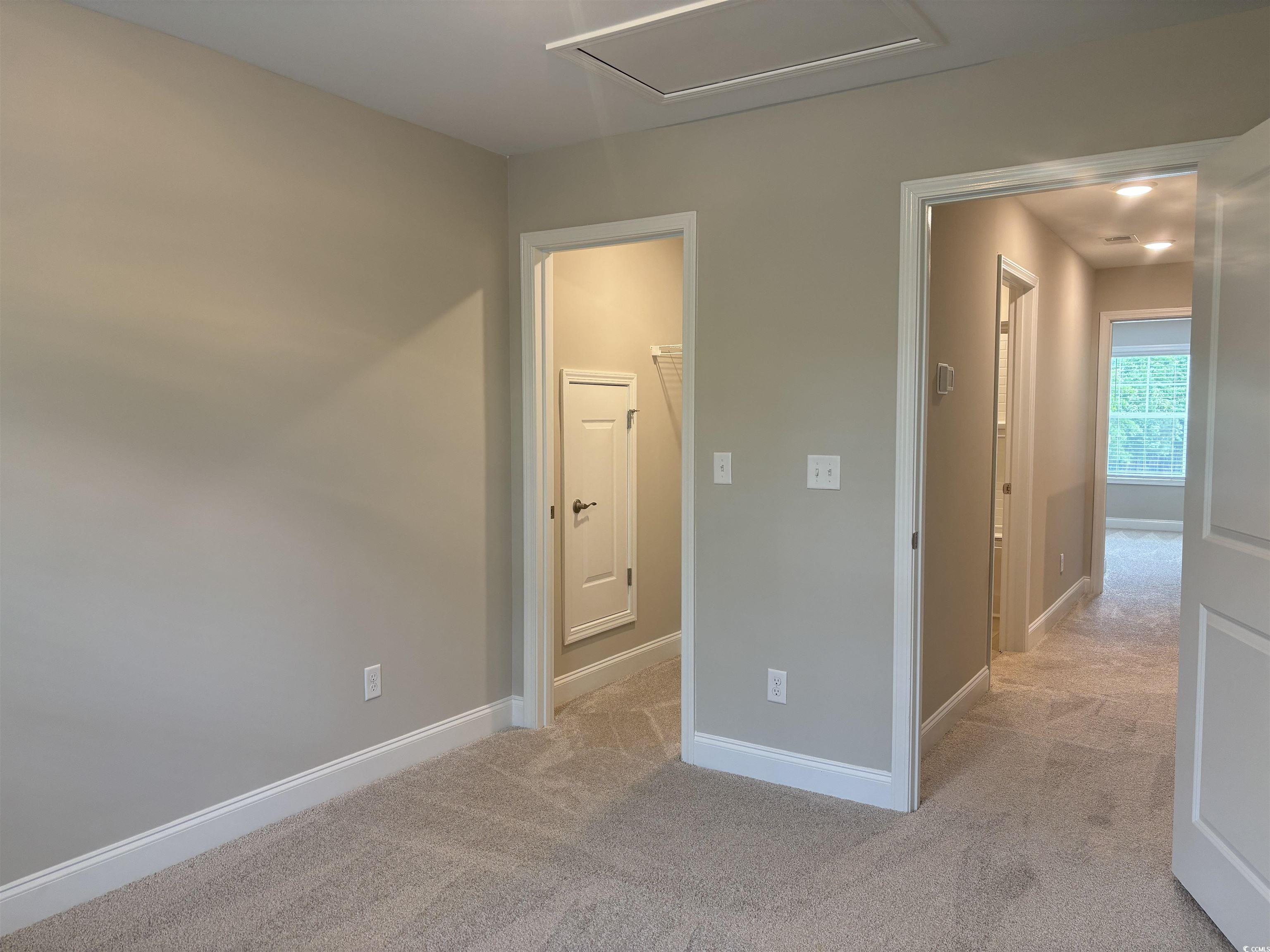 3125 Tiger Tail Road Conway, SC 29526 - Photo 26 of 37 Unfurnished bedroom with light carpet, baseboards, attic access, and a walk in closet