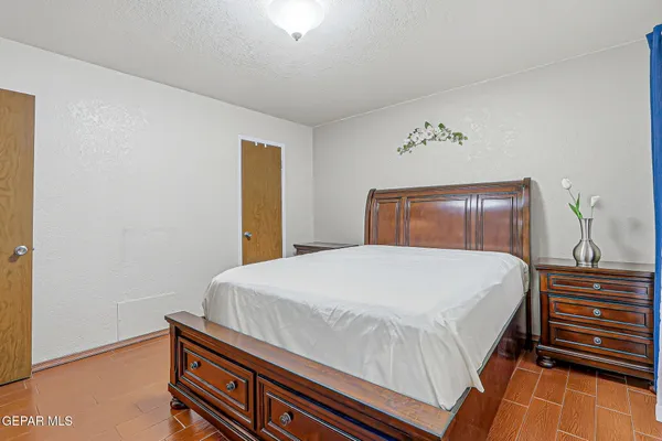 a bedroom with a bed and a dresser