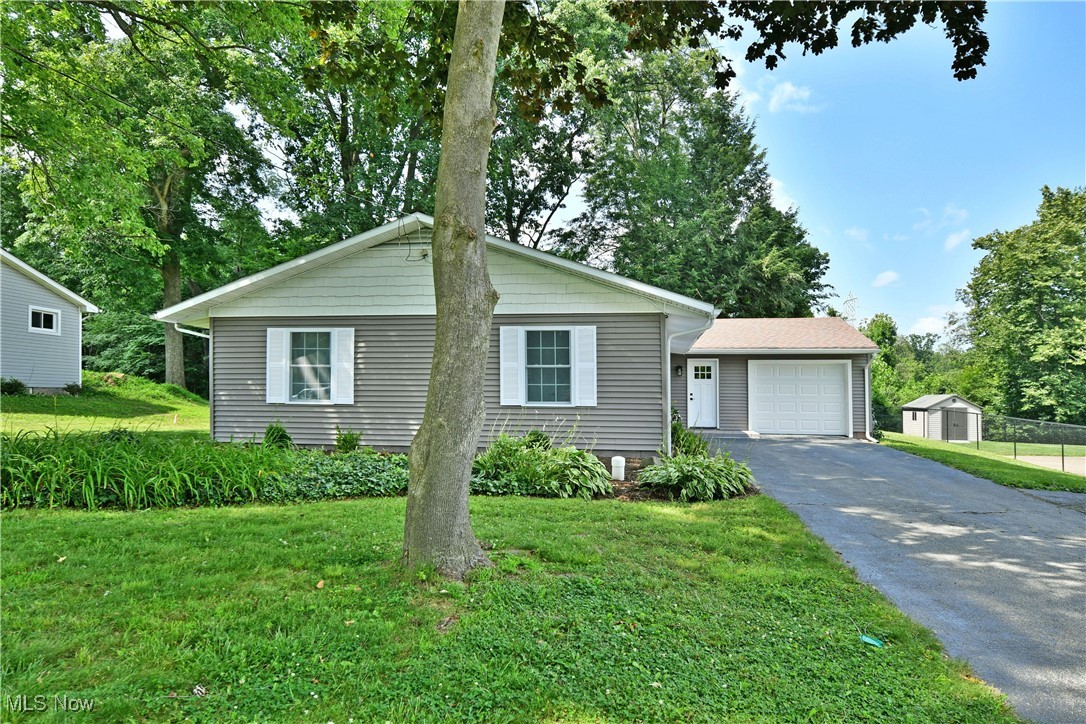 7655 Connelly Road Masury, OH 44438 - Photo 2 of 46 Ranch-style home featuring driveway, a front lawn, and a storage unit