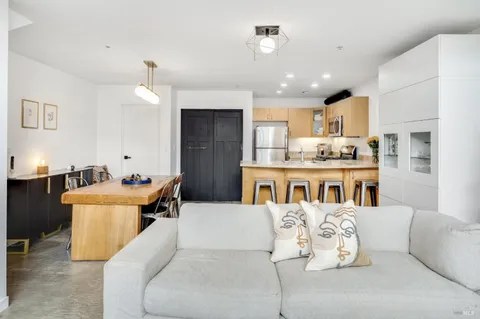 a living room with furniture and kitchen view