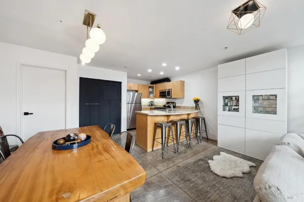 a bedroom with a bed and a view of kitchen