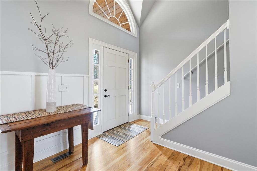 217 Wild Turkey Ridge Ball Ground, GA 30107 - Photo 13 of 55 a view of a hallway with wooden floor and staircase