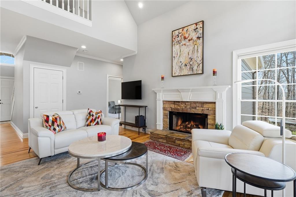 217 Wild Turkey Ridge Ball Ground, GA 30107 - Photo 15 of 55 a living room with furniture a fireplace and a flat screen tv