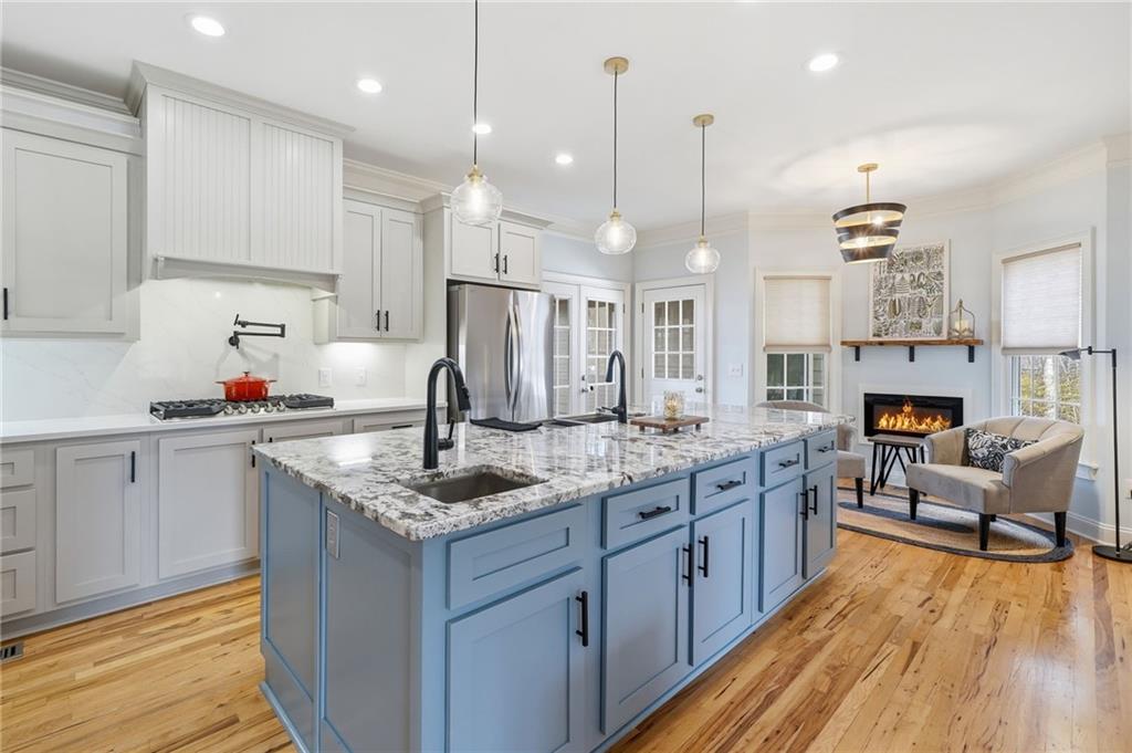 217 Wild Turkey Ridge Ball Ground, GA 30107 - Photo 17 of 55 a kitchen with cabinets a sink a stove and a wooden floor
