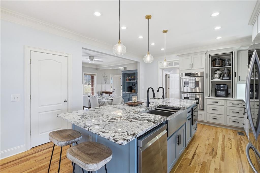 217 Wild Turkey Ridge Ball Ground, GA 30107 - Photo 18 of 55 a kitchen with kitchen island granite countertop a table and chairs in it