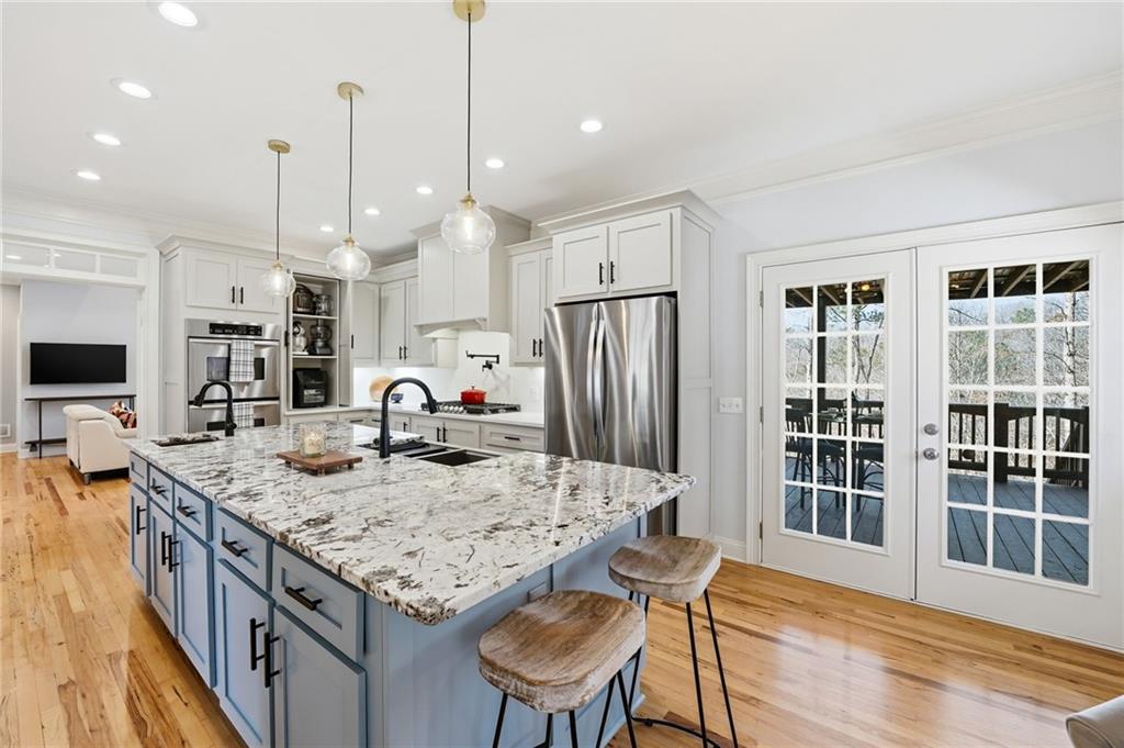 217 Wild Turkey Ridge Ball Ground, GA 30107 - Photo 19 of 55 a kitchen with stainless steel appliances granite countertop a kitchen island a stove and a sink