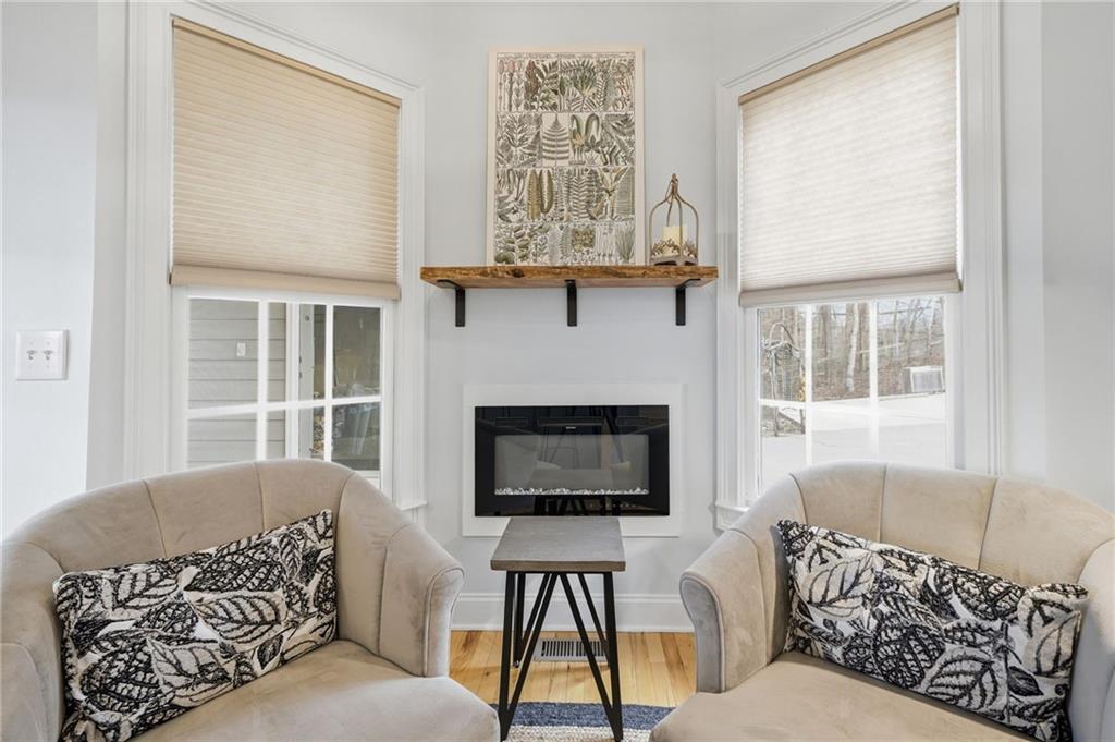 217 Wild Turkey Ridge Ball Ground, GA 30107 - Photo 20 of 55 a living room with furniture a window and a fireplace