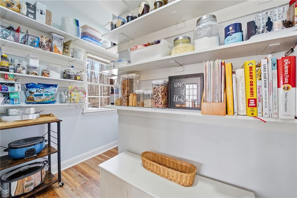 217 Wild Turkey Ridge Ball Ground, GA 30107 - Photo 24 of 55 a hallway with furniture and book shelf