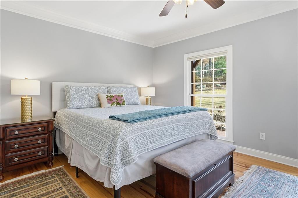 217 Wild Turkey Ridge Ball Ground, GA 30107 - Photo 26 of 55 a bedroom with a bed and a night stand