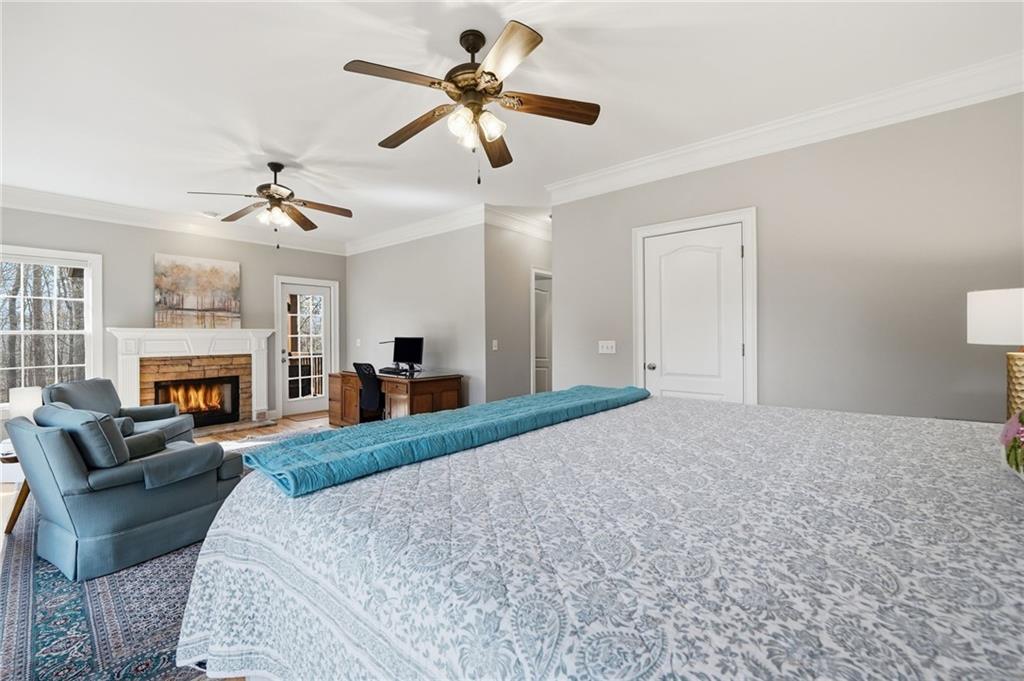 217 Wild Turkey Ridge Ball Ground, GA 30107 - Photo 27 of 55 a large bedroom with furniture fireplace and a window