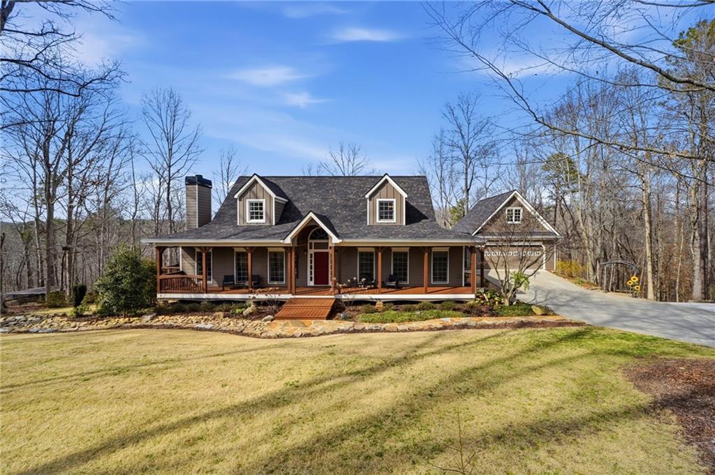 217 Wild Turkey Ridge Ball Ground, GA 30107 - Photo 3 of 55 a front view of a house with a yard