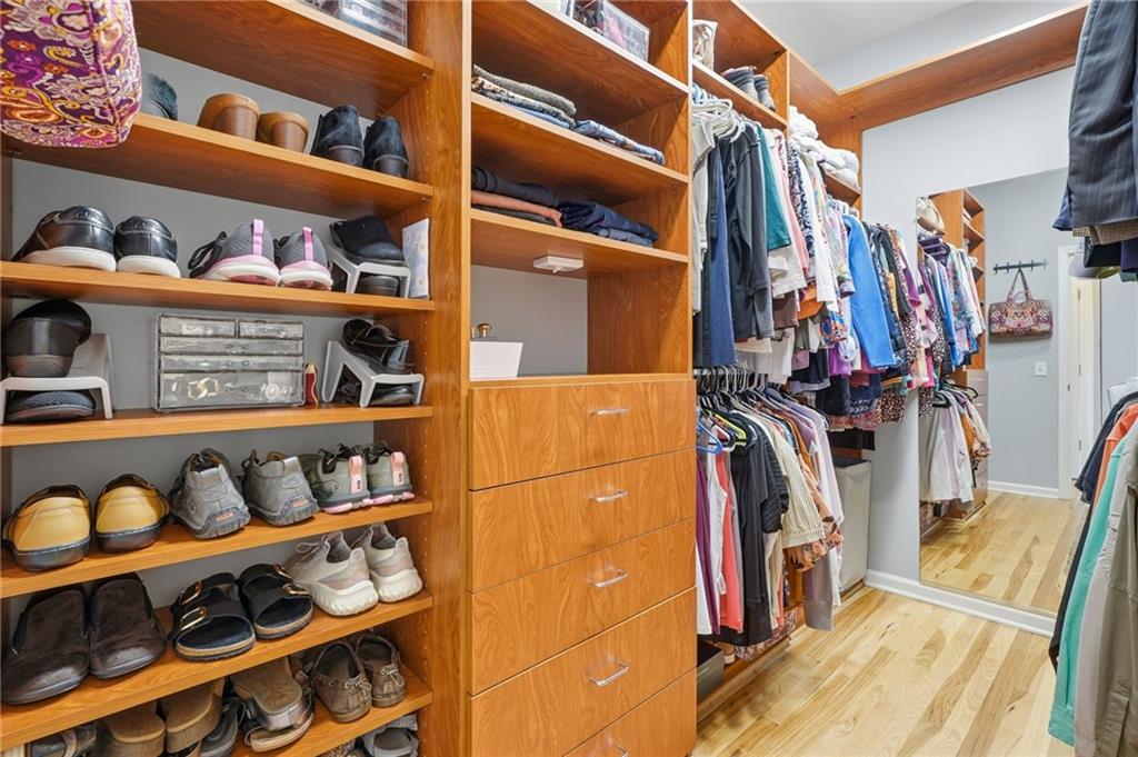217 Wild Turkey Ridge Ball Ground, GA 30107 - Photo 31 of 55 a view of walk in closet with clothes and shoes