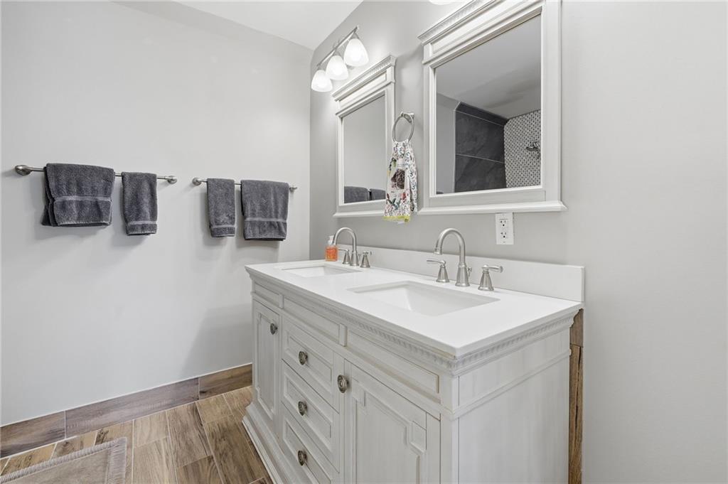 217 Wild Turkey Ridge Ball Ground, GA 30107 - Photo 35 of 55 a bathroom with a sink vanity and mirror