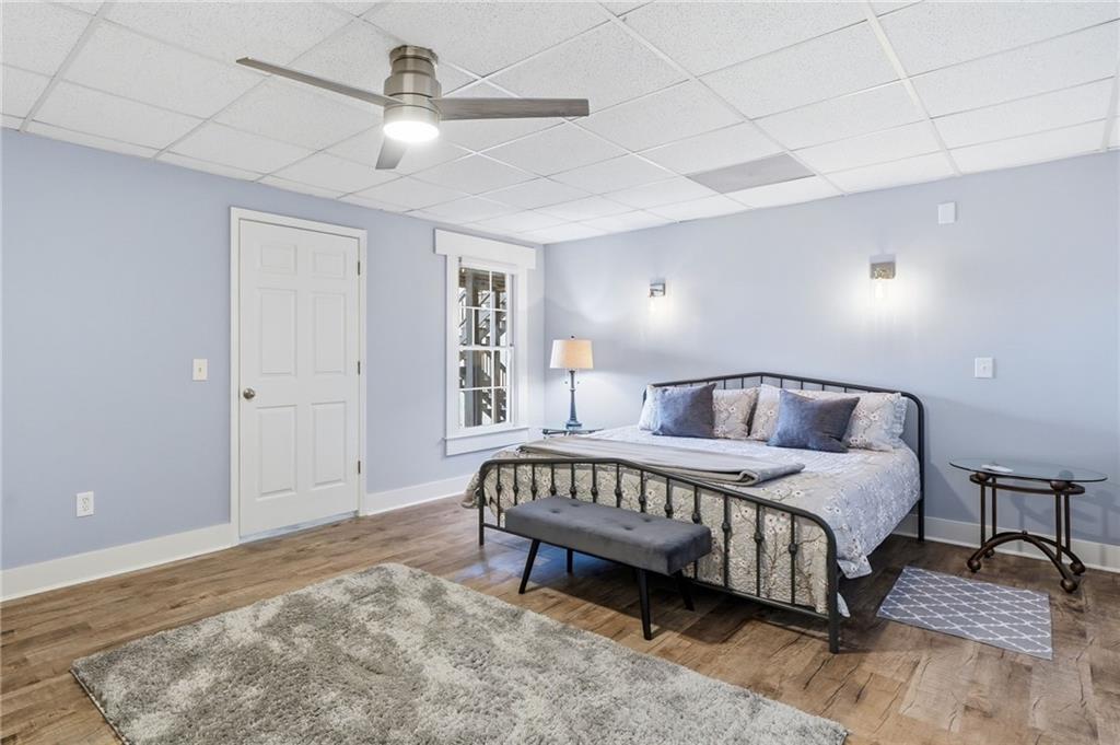 217 Wild Turkey Ridge Ball Ground, GA 30107 - Photo 39 of 55 a spacious bedroom with a bed and a chandelier