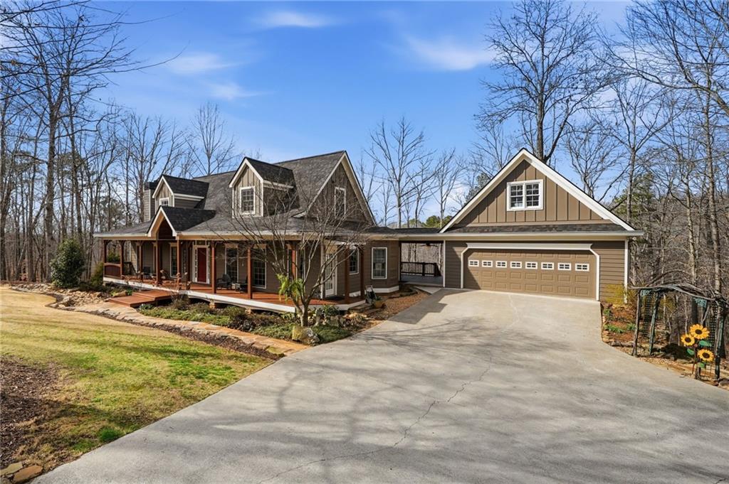 217 Wild Turkey Ridge Ball Ground, GA 30107 - Photo 4 of 55 a front view of a house with garden and trees
