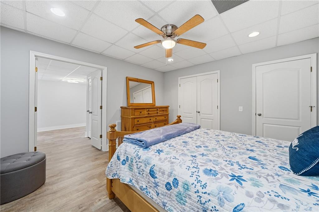 217 Wild Turkey Ridge Ball Ground, GA 30107 - Photo 41 of 55 a bedroom with a bed and a chandelier