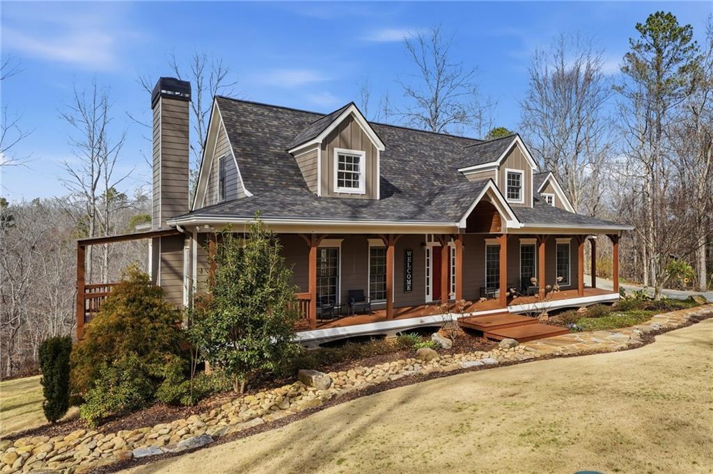 217 Wild Turkey Ridge Ball Ground, GA 30107 - Photo 5 of 55 a front view of a house with garden
