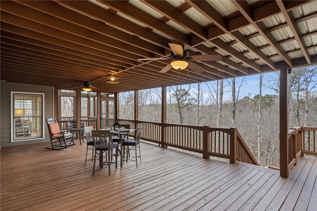 217 Wild Turkey Ridge Ball Ground, GA 30107 - Photo 8 of 55 a view of a patio with table and chairs and wooden floor