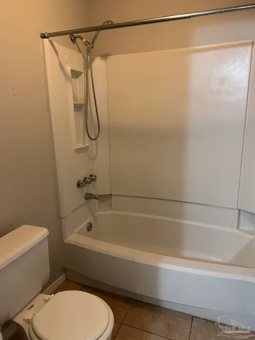 a bathroom with a shower and a toilet