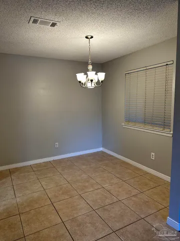 a view of a livingroom with a chandelier fan