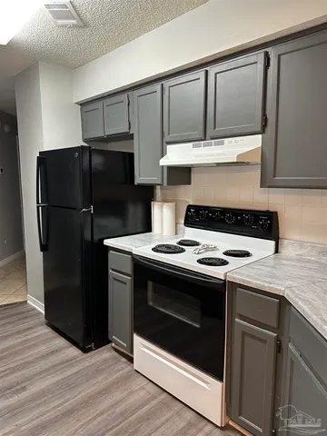 a kitchen with a stove and a refrigerator
