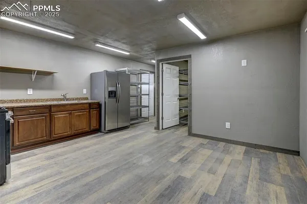 an empty room with wooden floor and mirror