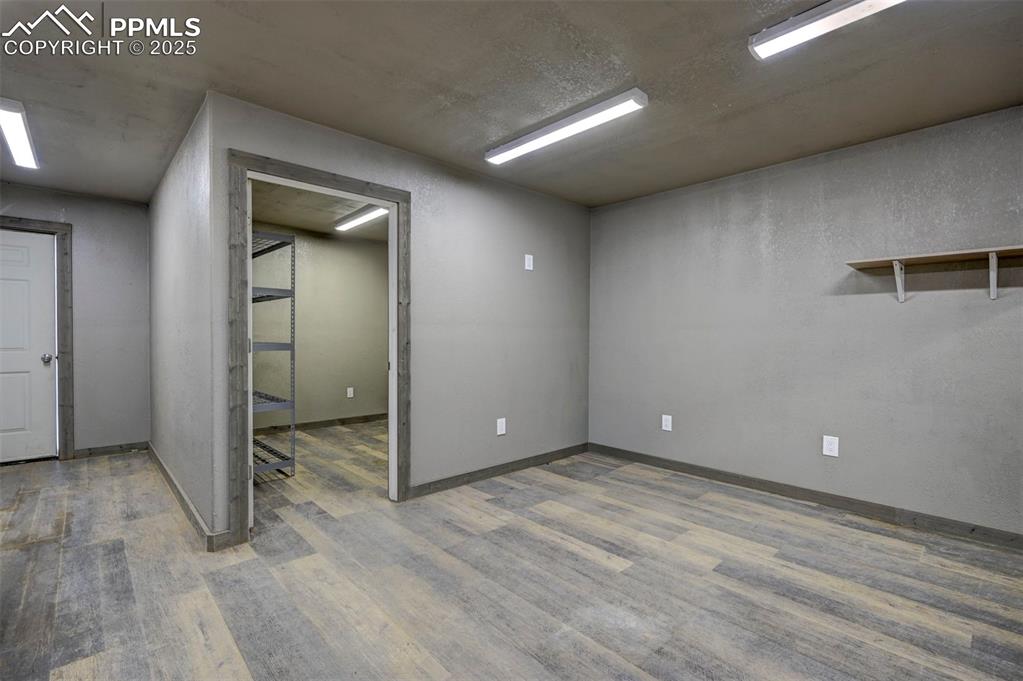 2880 North Ramah Highway Yoder, CO 80864 - Photo 21 of 50 an empty room with wooden floor and mirror