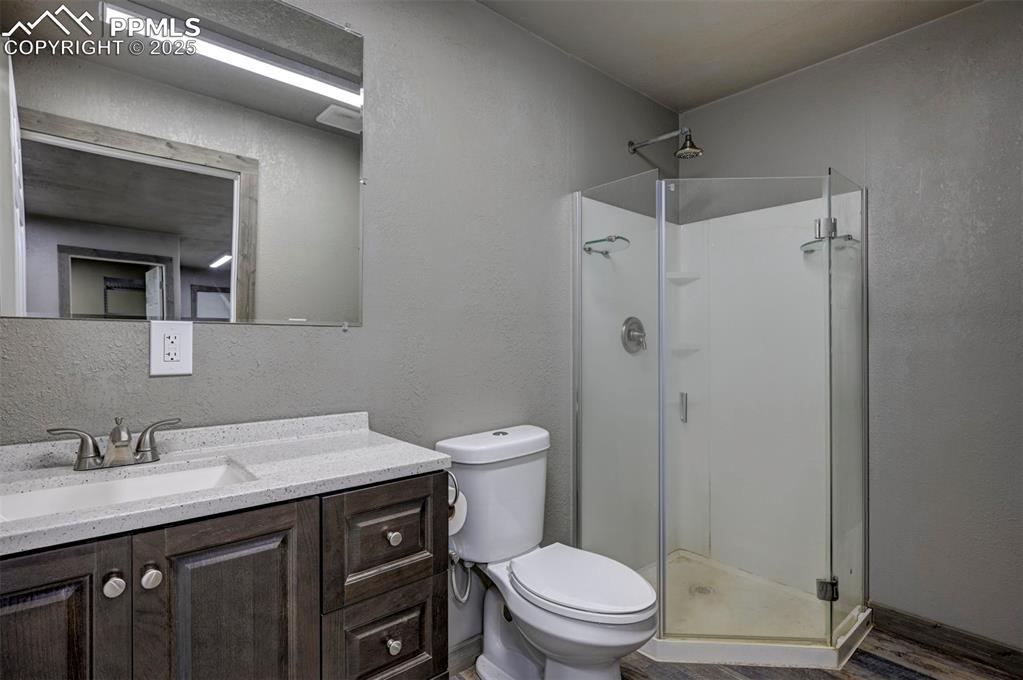 2880 North Ramah Highway Yoder, CO 80864 - Photo 26 of 50 a bathroom with a granite countertop sink toilet and shower