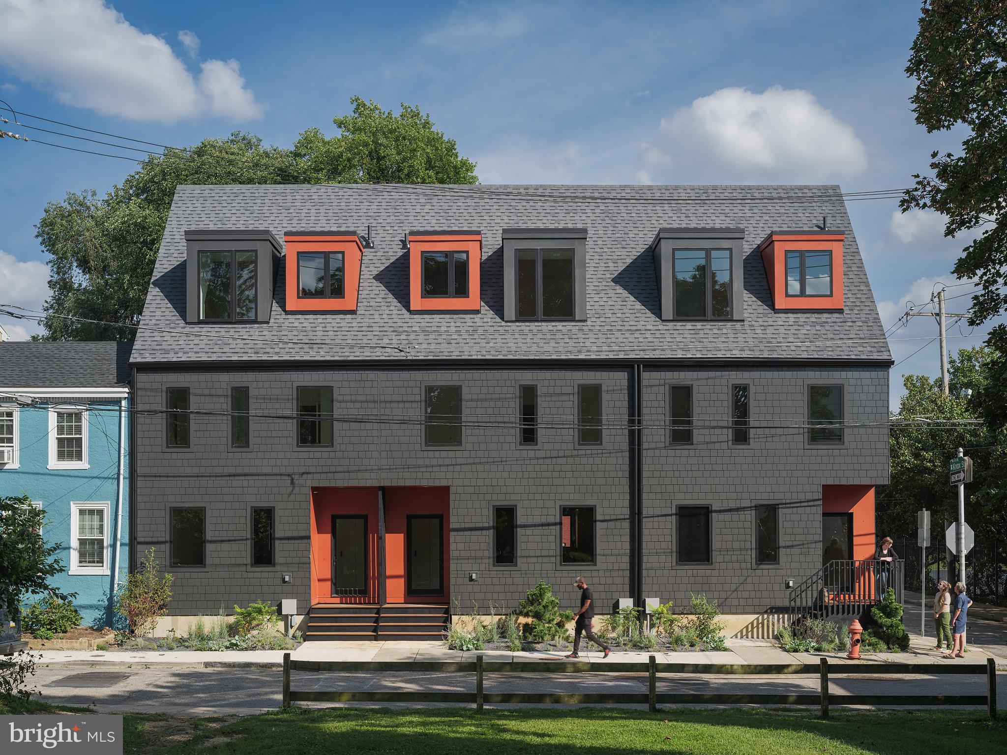 a front view of building with yard and green space