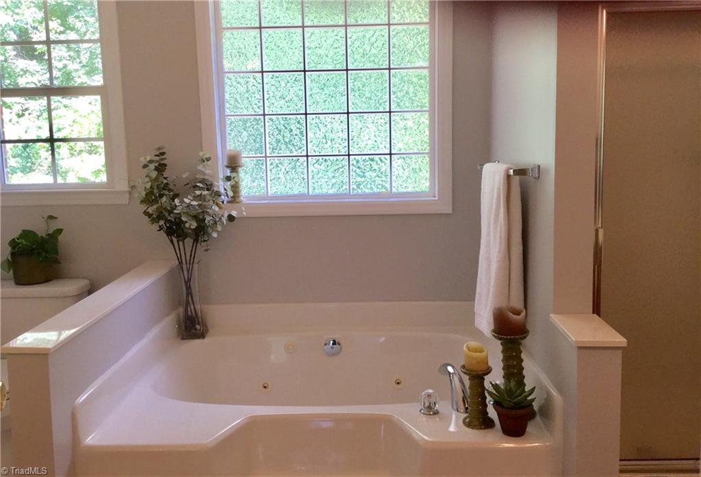 129 Creekside Ridge Drive High Point, NC 27265 - Photo 11 of 14 Master bath with jetted tub, shower and 2 separate his/ hers vanities.