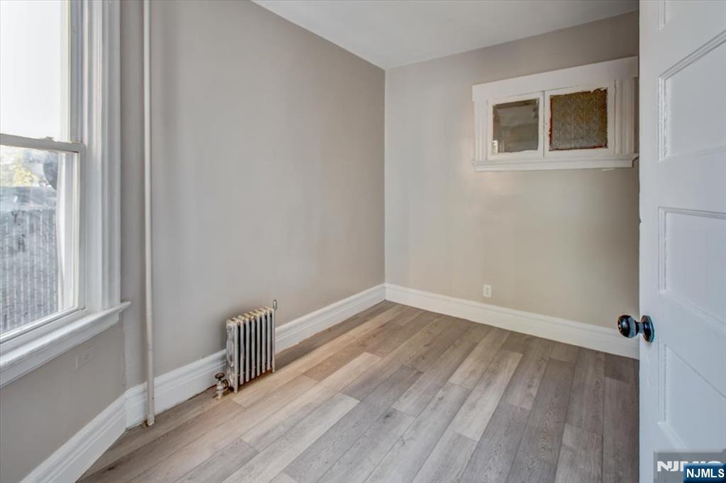 70 South 9th Street Newark, NJ 07107 - Photo 17 of 29 a view of a room with wooden floor and a window