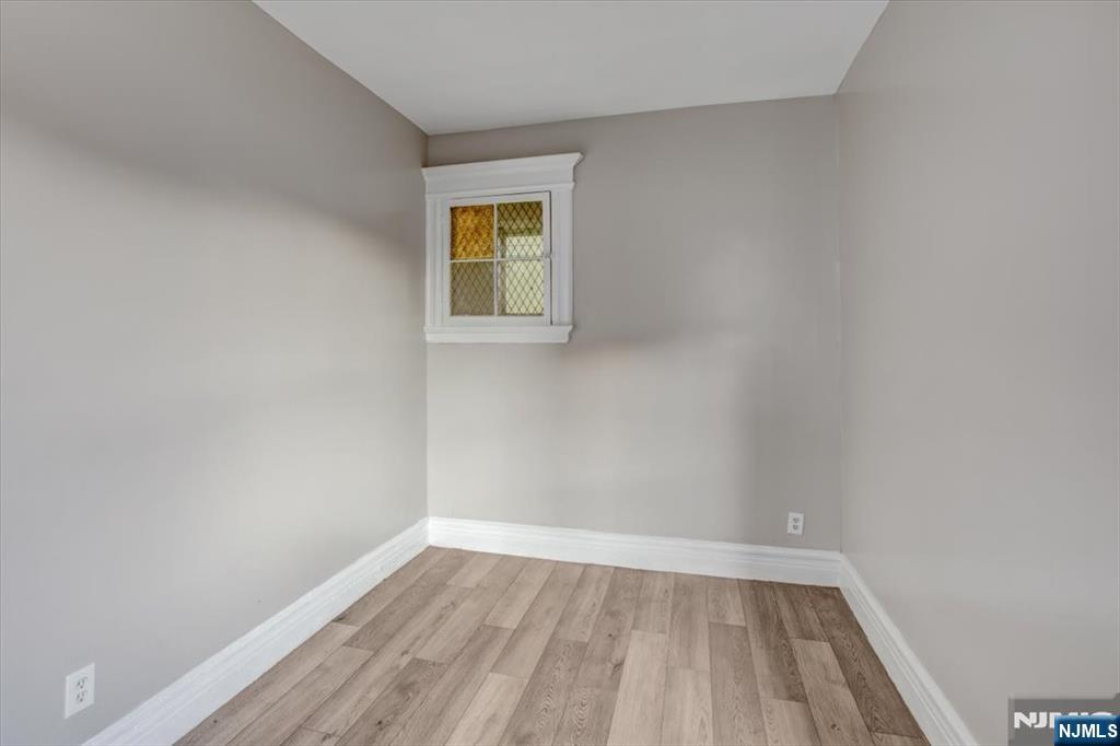 70 South 9th Street Newark, NJ 07107 - Photo 18 of 29 a view of an empty room with wooden floor and a window