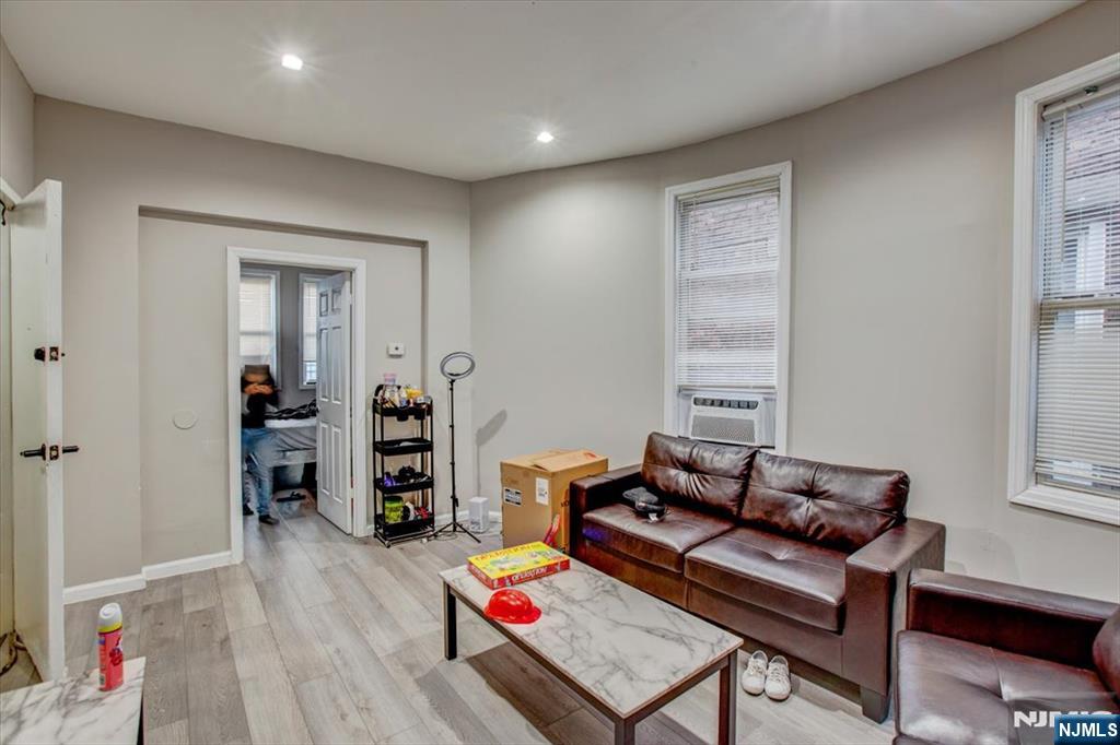 70 South 9th Street Newark, NJ 07107 - Photo 21 of 29 a living room with furniture and wooden floor
