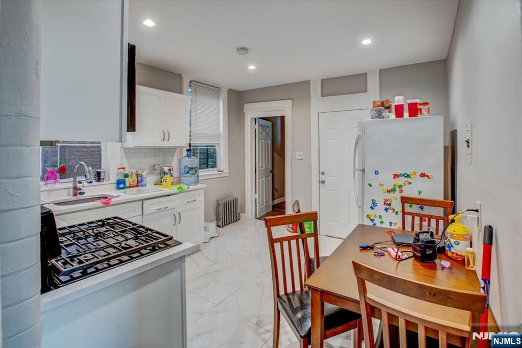 70 South 9th Street Newark, NJ 07107 - Photo 25 of 29 a kitchen with a table and chairs in it