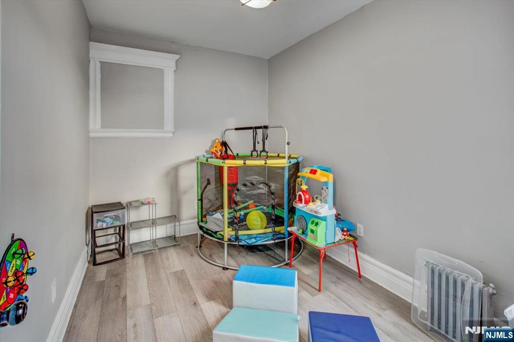 70 South 9th Street Newark, NJ 07107 - Photo 28 of 29 a living room with furniture and a wooden floor