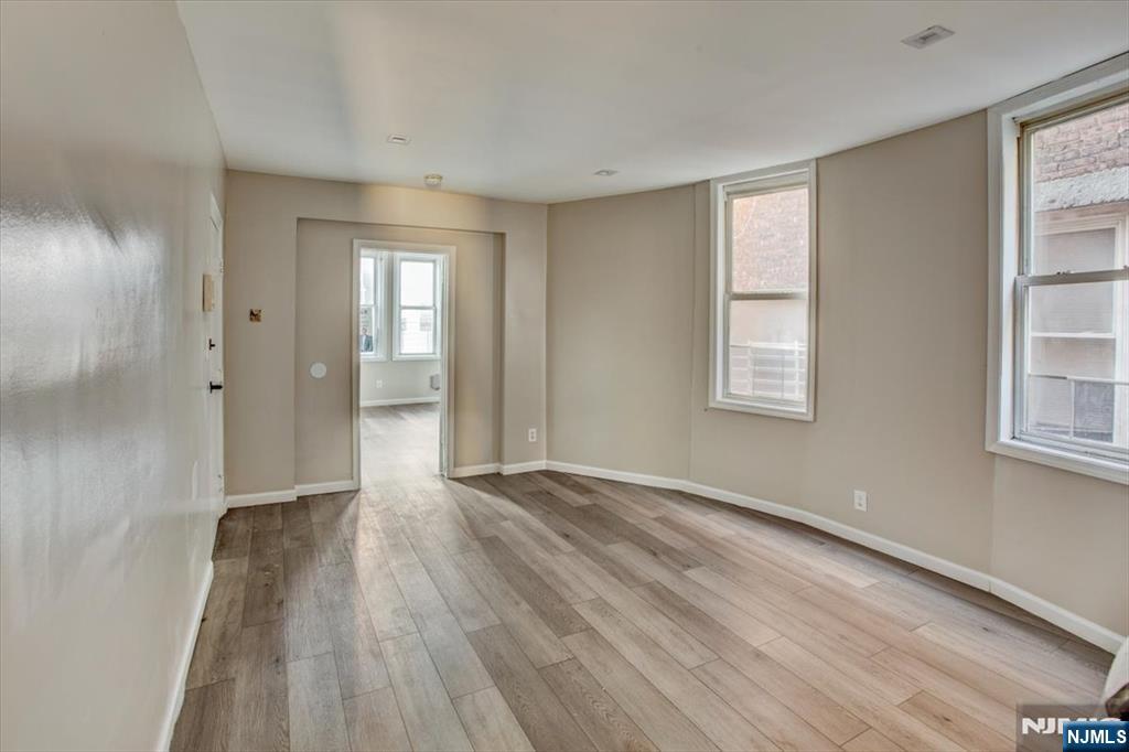70 South 9th Street Newark, NJ 07107 - Photo 7 of 29 a view of an empty room with wooden floor and a window