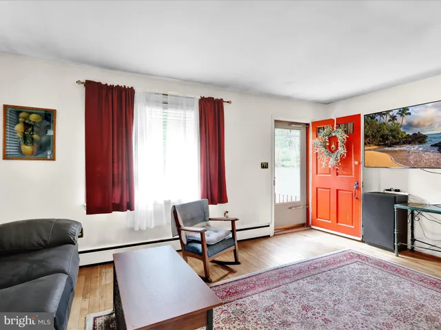 a living room with furniture a rug and a window