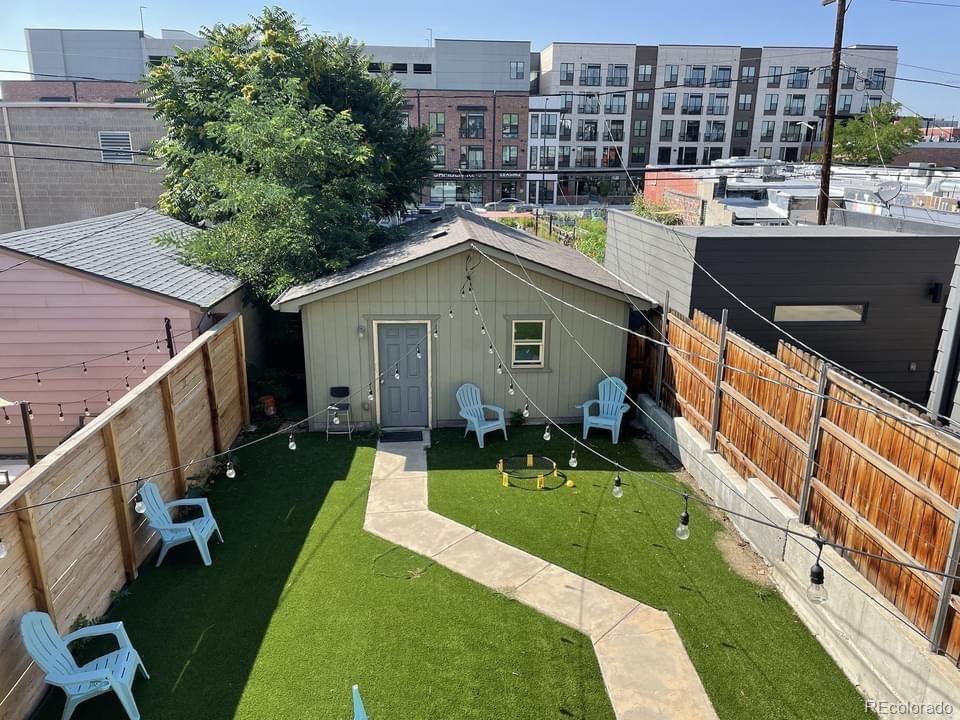 3217 Lawrence Street Denver, CO 80205 - Photo 2 of 13 a aerial view of a house with a yard table and chairs