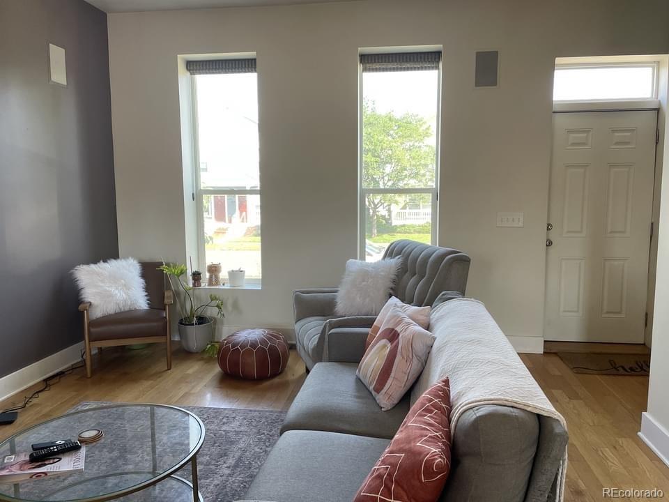 3217 Lawrence Street Denver, CO 80205 - Photo 3 of 13 a living room with furniture and a window
