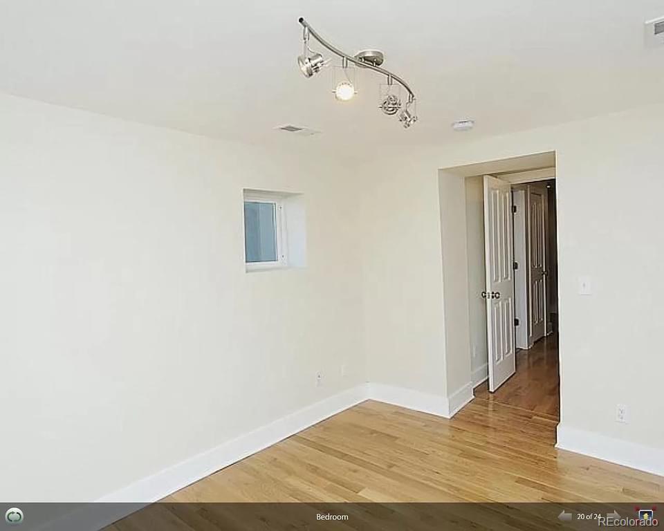 3217 Lawrence Street Denver, CO 80205 - Photo 4 of 13 a view of a room with wooden floor