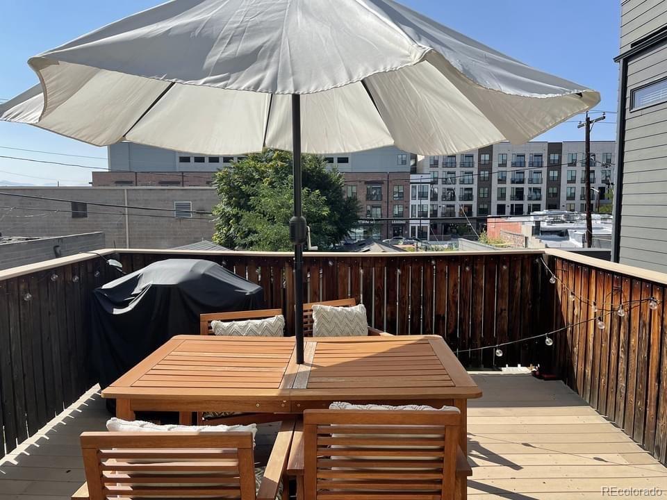 3217 Lawrence Street Denver, CO 80205 - Photo 6 of 13 a view of a patio with a table and chairs under an umbrella