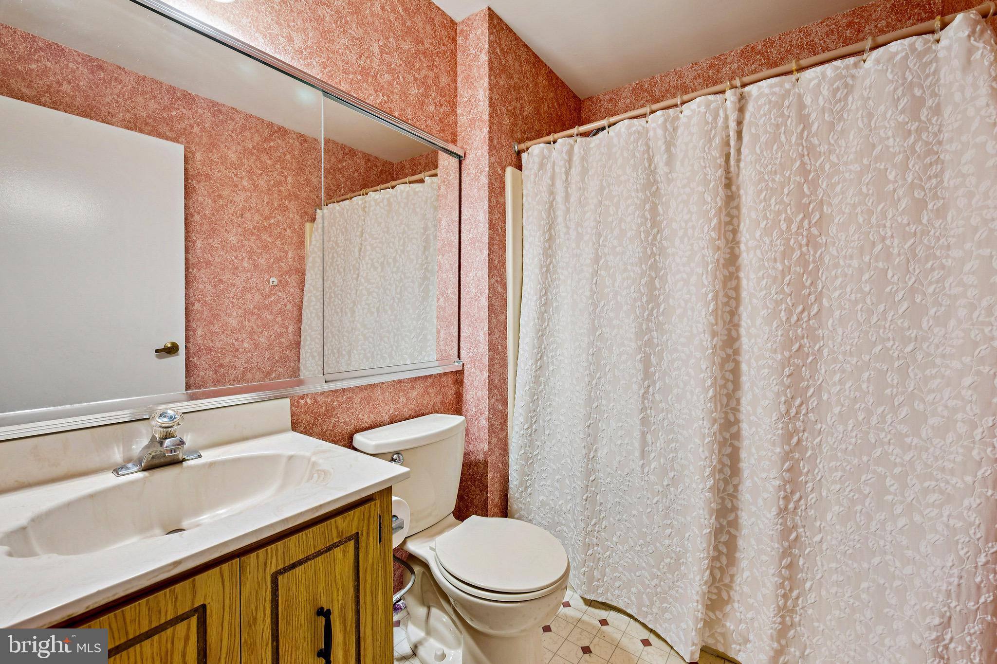112 Village Lane Mount Laurel, NJ 08054 - Photo 15 of 17 a bathroom with a sink a toilet a mirror and shower curtain