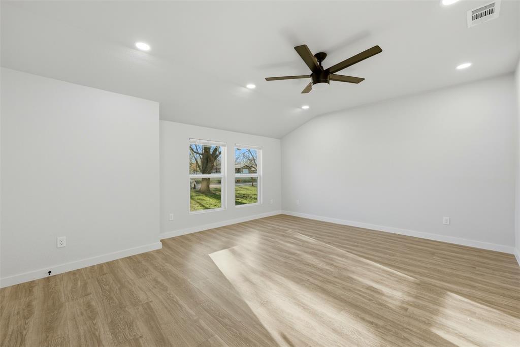 502 Madison Street Cleburne, TX 76033 - Photo 15 of 30 wooden floor in an empty room with a window