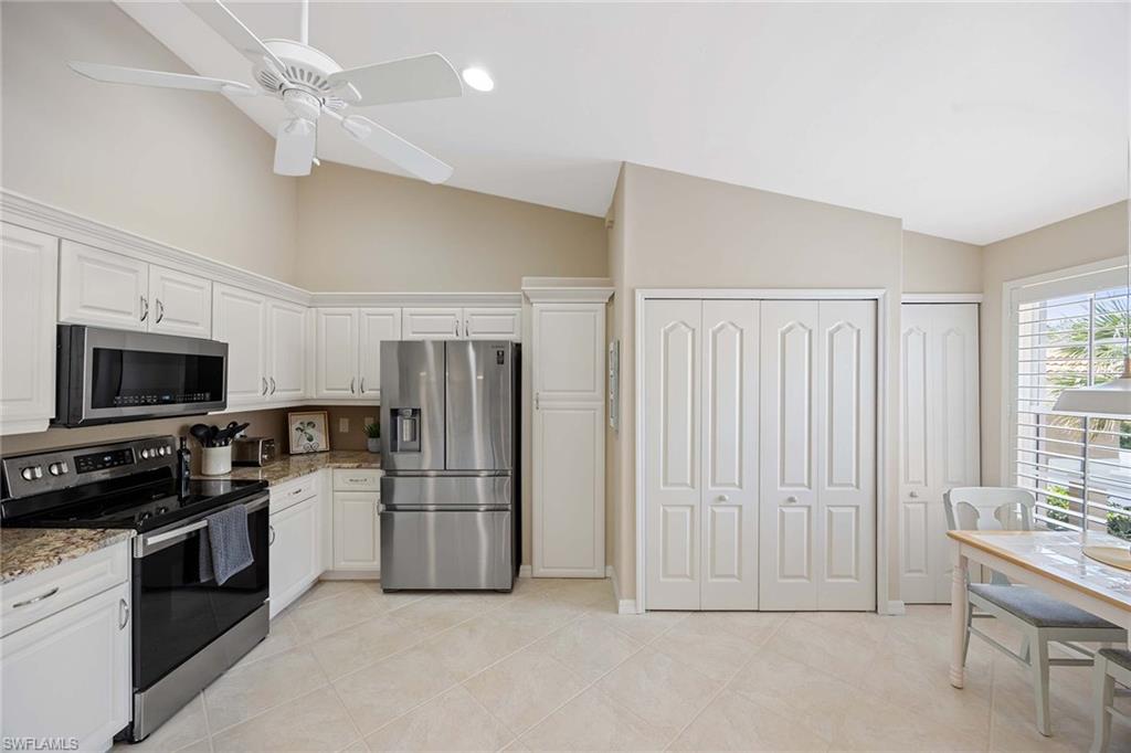 9030 Spring Run Boulevard, Unit 508 Estero, FL 34135 - Photo 11 of 41 a kitchen with cabinets and stainless steel appliances