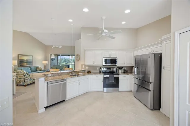 a large kitchen with a large window and stainless steel appliances
